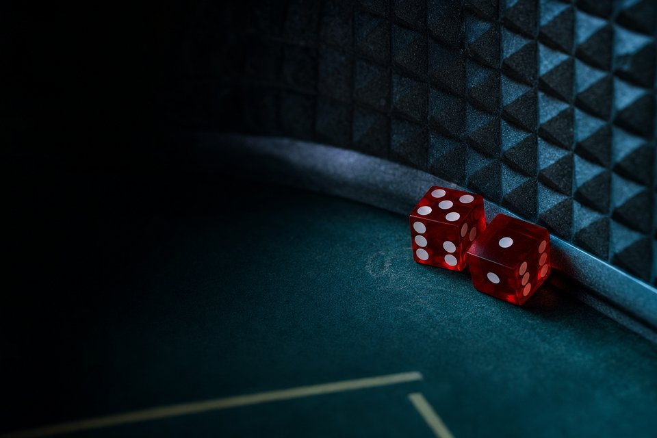 A pair of red casino dice resting against the diamond-patterned back wall of a craps table after a throw (AI-generated image)